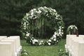 Intimate wedding ceremony arch with flower petals and candles