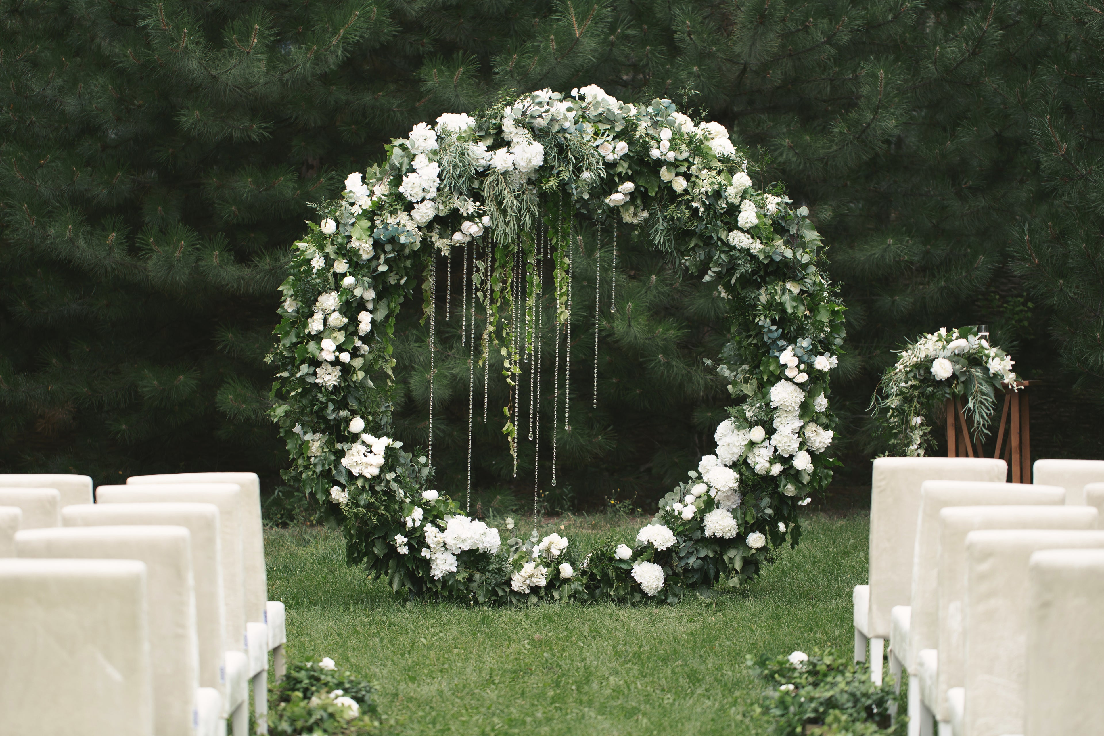 Intimate wedding ceremony arch with flower petals and candles