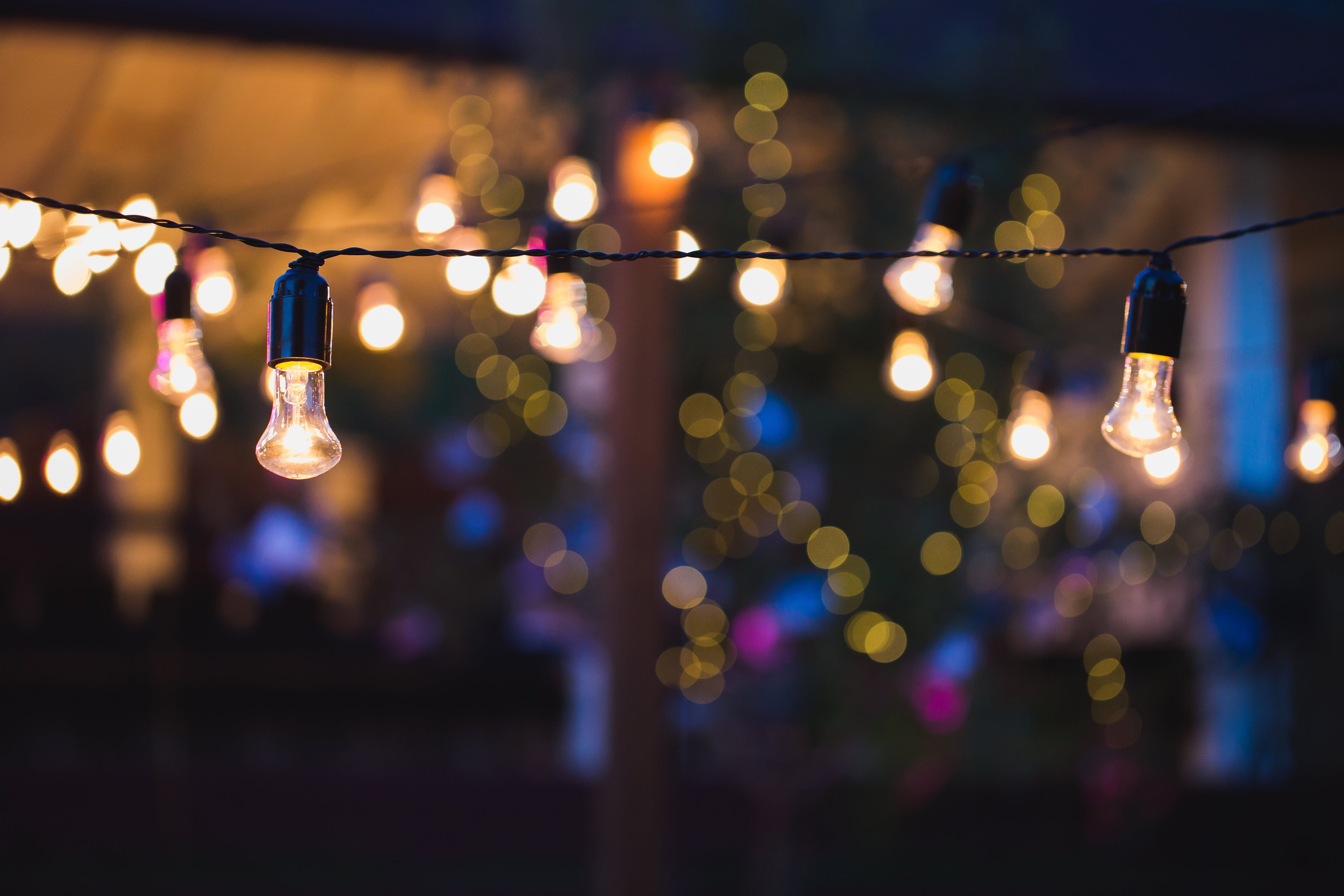 String lights and warm bulb decor at an outdoor community celebration