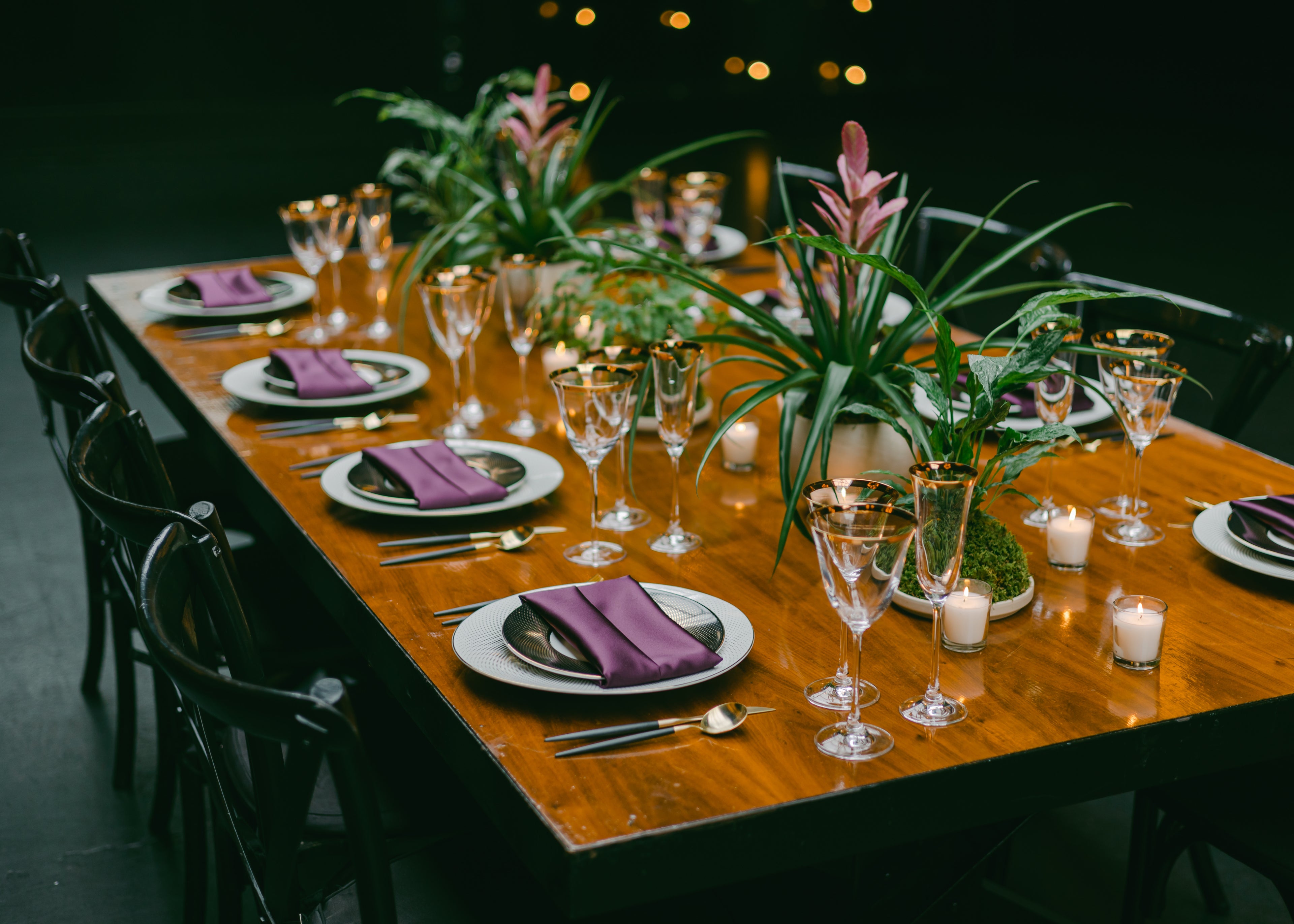 Elegant dining setup with floral arrangements and warm ambient lighting