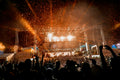 Large-scale festival music stage with dramatic laser and lighting production