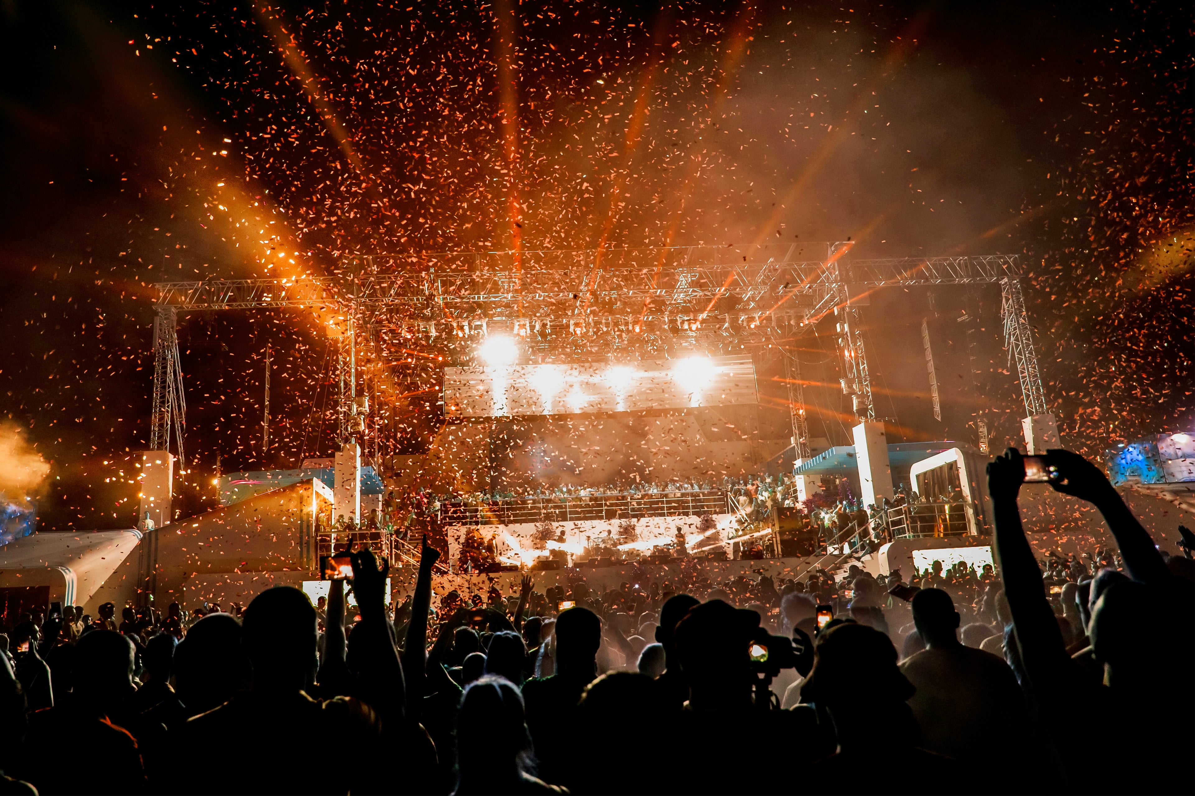 Large-scale festival music stage with dramatic laser and lighting production